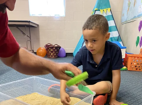 A child exploring a hands-on activity at Springdale’s VBS